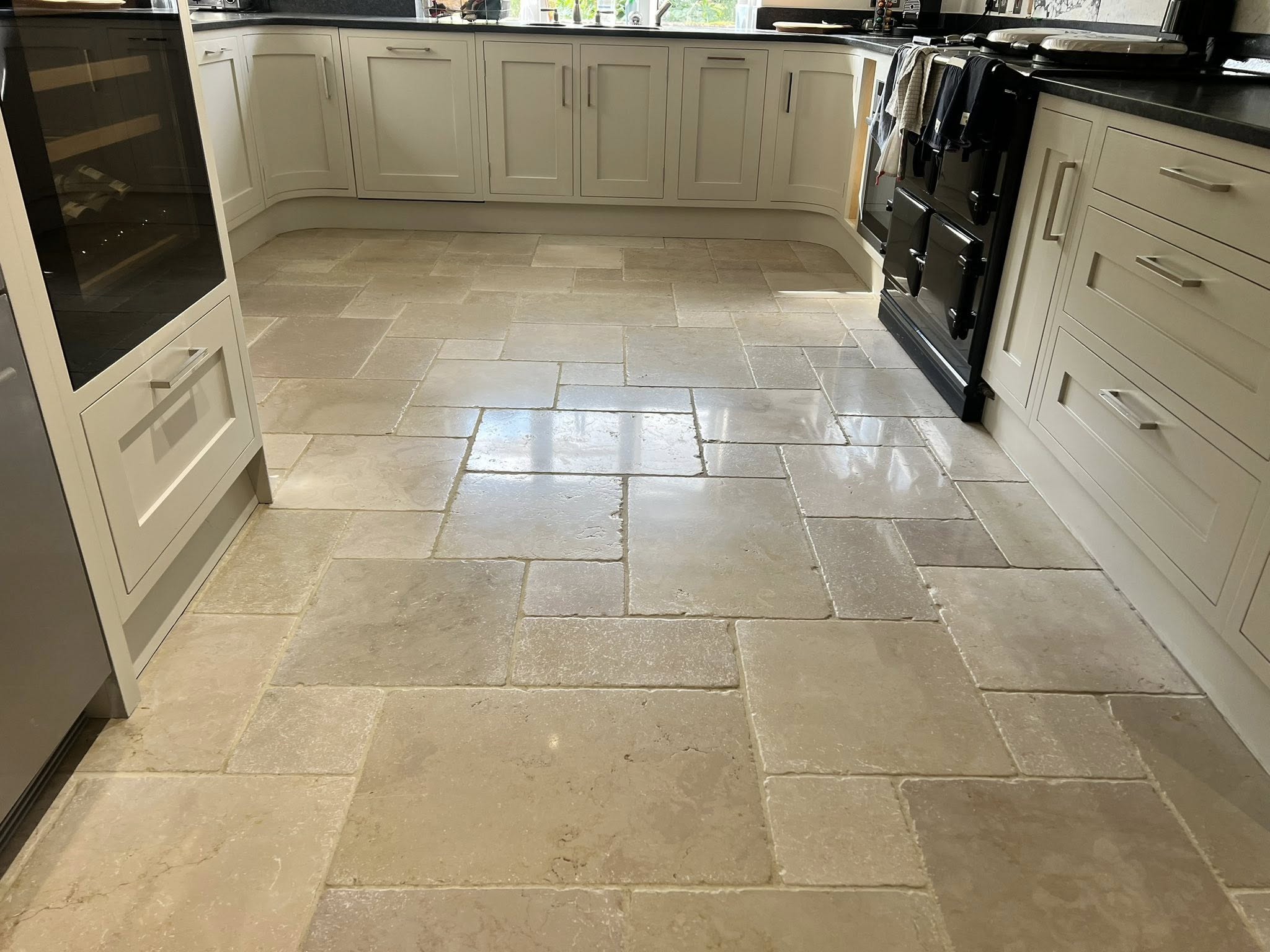Limestone kitchen floor cleaned and sealed by Floorless Restoration