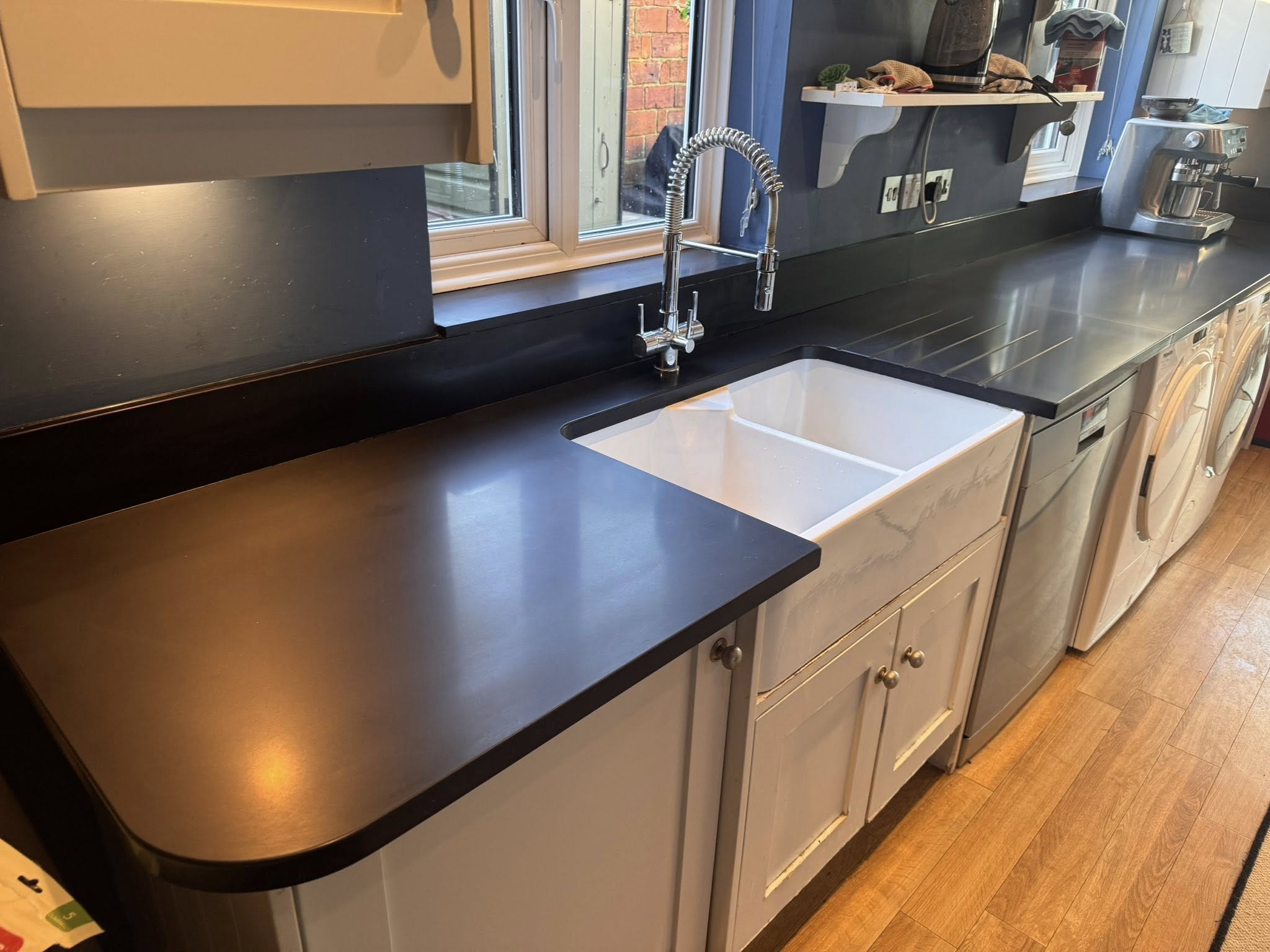 Black granite worktop restoration by Floorless Restoration